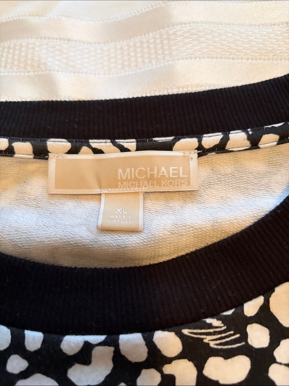 MICHAEL Michael Kors Black and White Printed light Sweatshirt with side zippers.